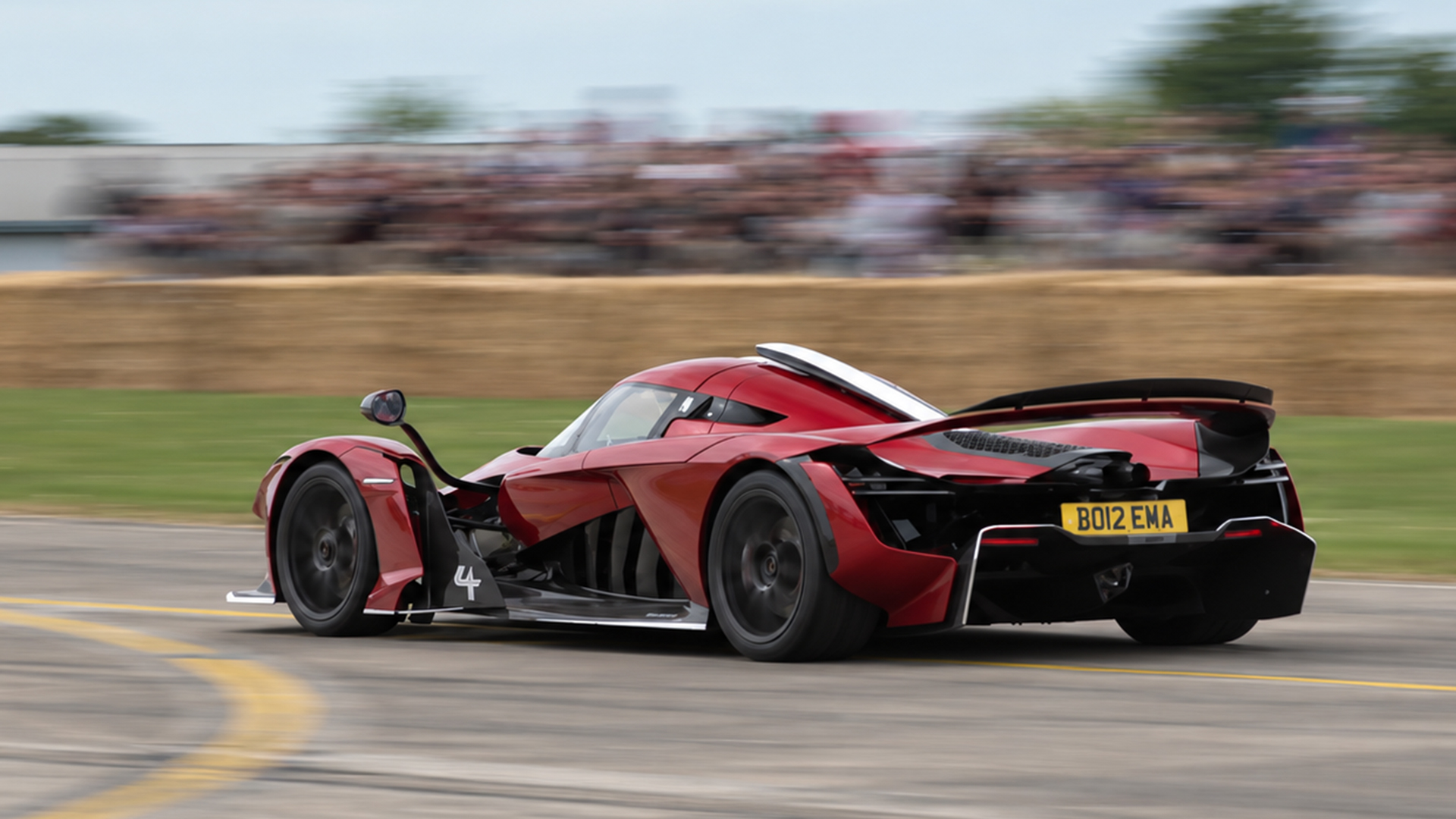 Aston Martin Valkyrie sprints down a straight in front of the crowd
