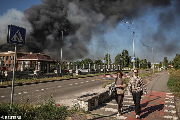 Residents passed the site of a Russian drone strike as Putin's barrage against Kyiv passed the 50-hour mark
