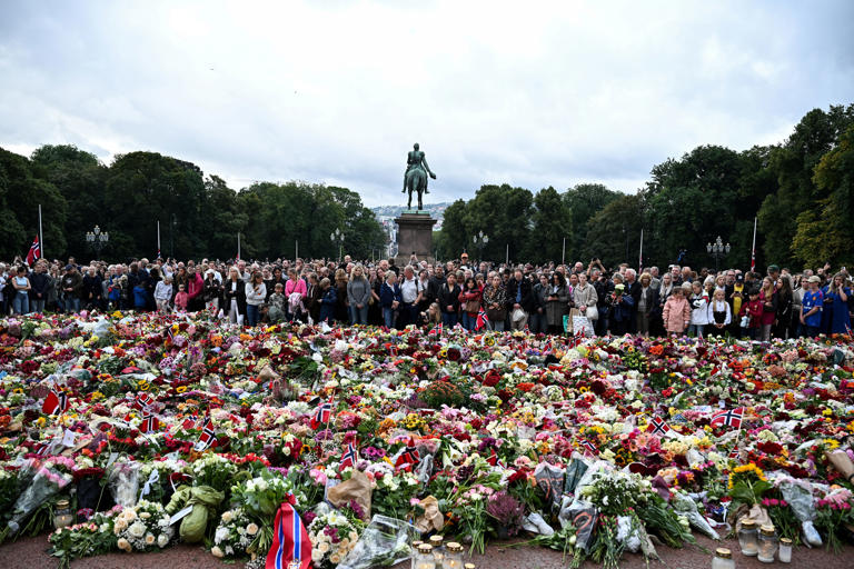 People gather to pay their respects outside the Royal Palace, following the death of Norway's King Harald (Reuters)