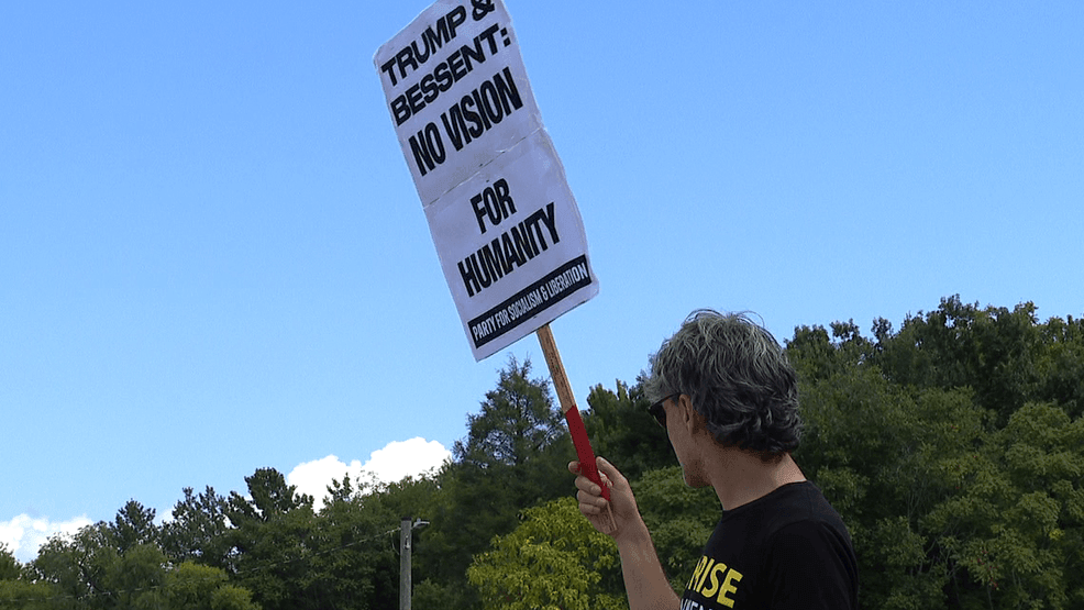 Protesters line Merrimon Avenue during G20 Finance Track meetings in Asheville