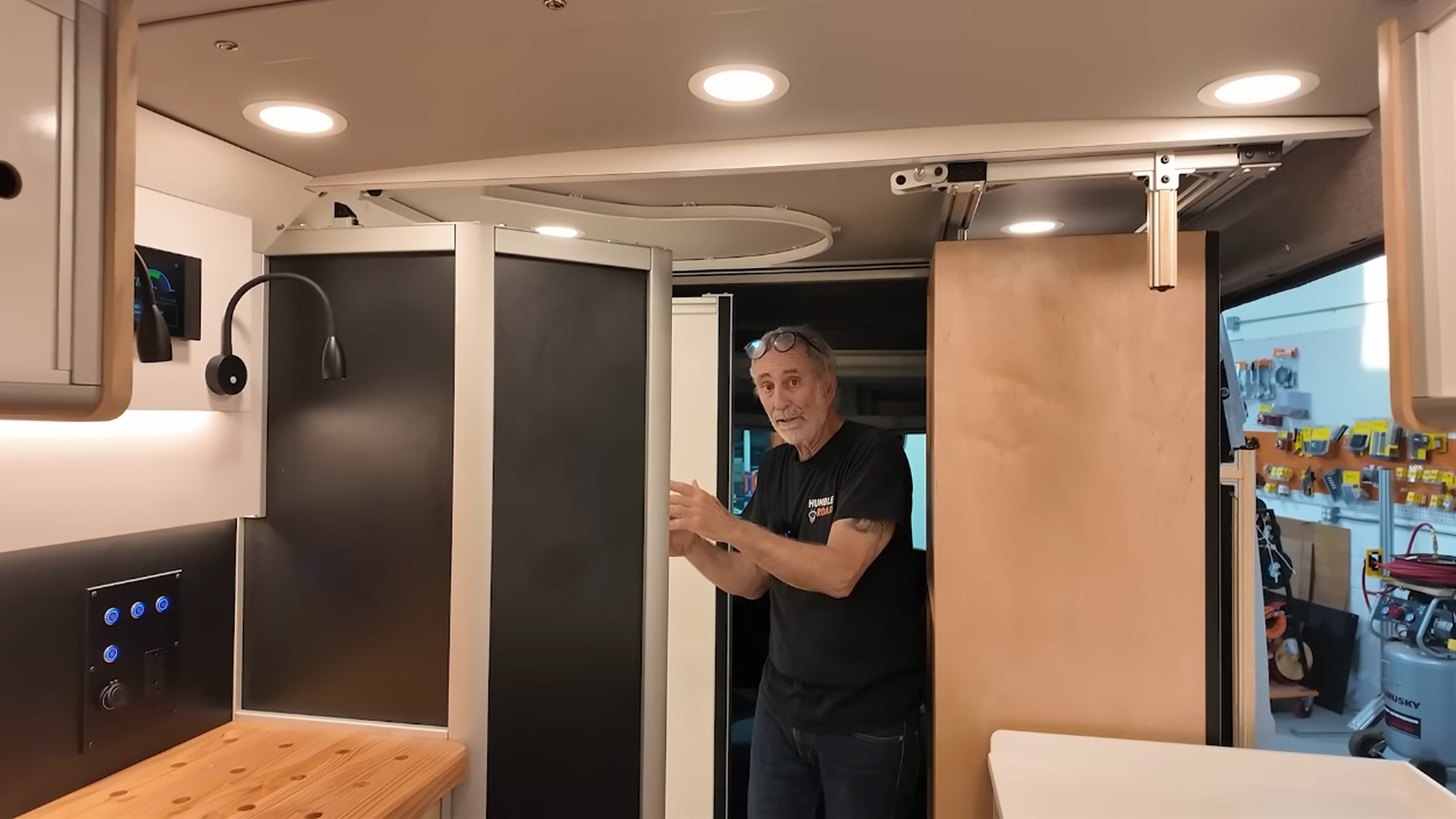This camper van hides a shower behind a clever workbench layout