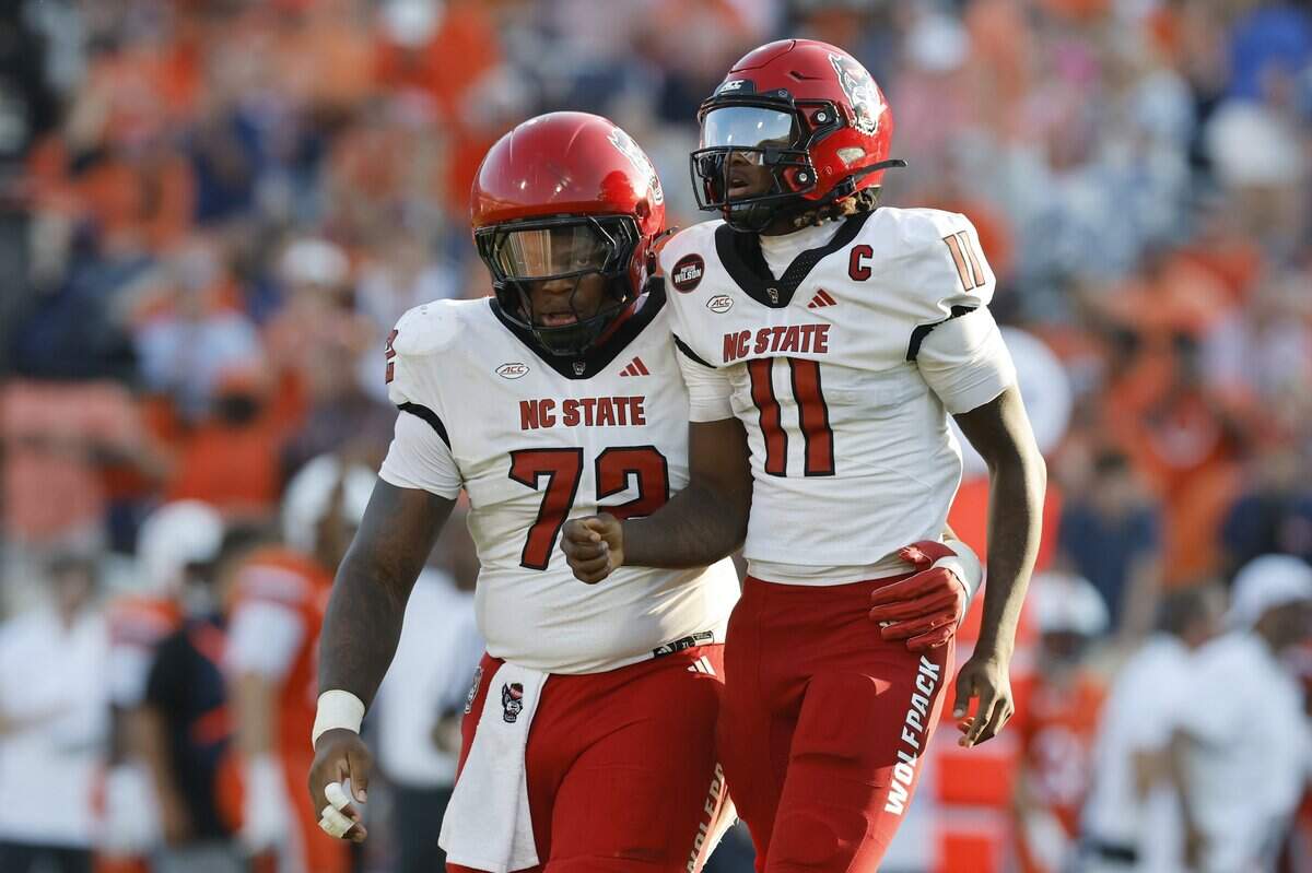 NC State football opens the season with big loss at Virginia. See photos from Week 0 game