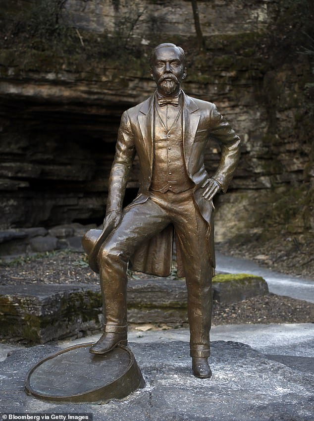 A statue of Jack Daniel stands in front of the limestone cave spring at Jack Daniel's Distillery in Lynchburg, Tennessee