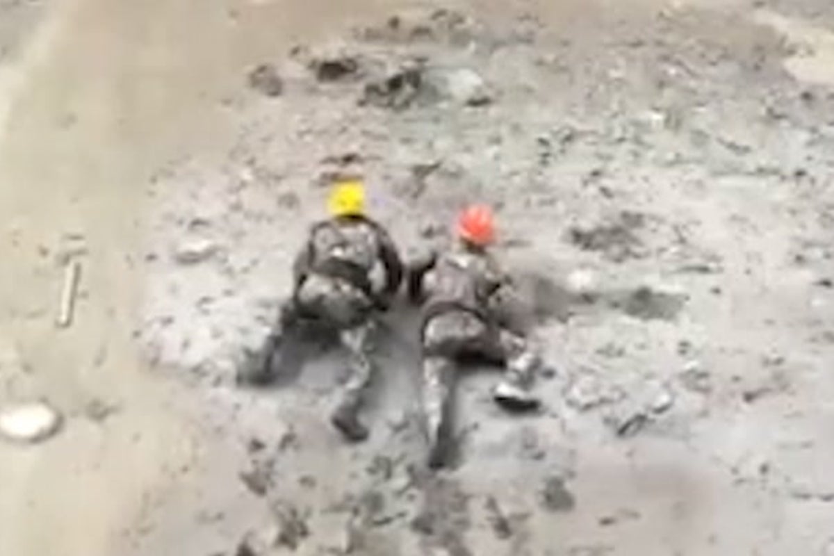 Nepal rescuers crawl through thick mud to save trapped workers