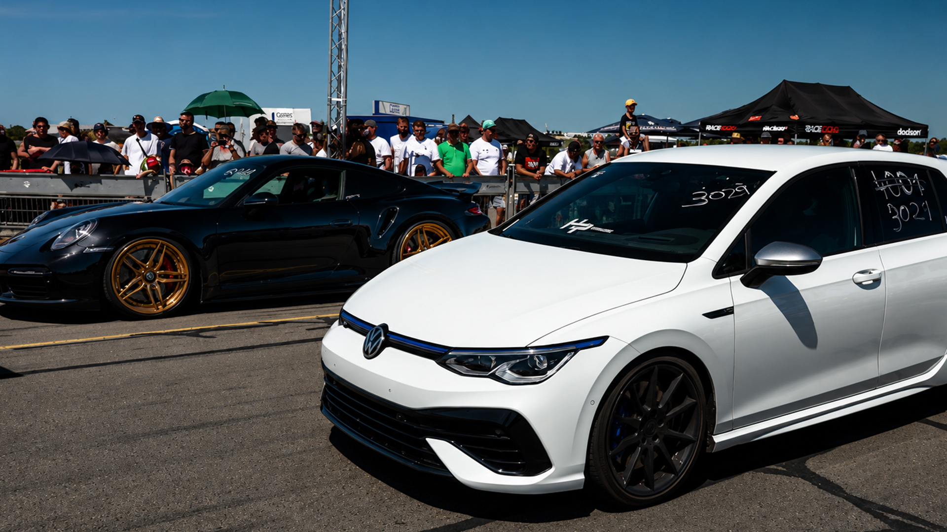 VW Golf R lines up against a Porsche 911 for a drag run