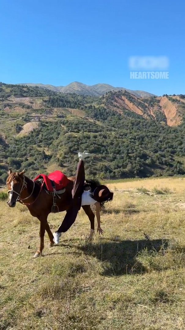 Girl falls off horse's back after standing stunt fails