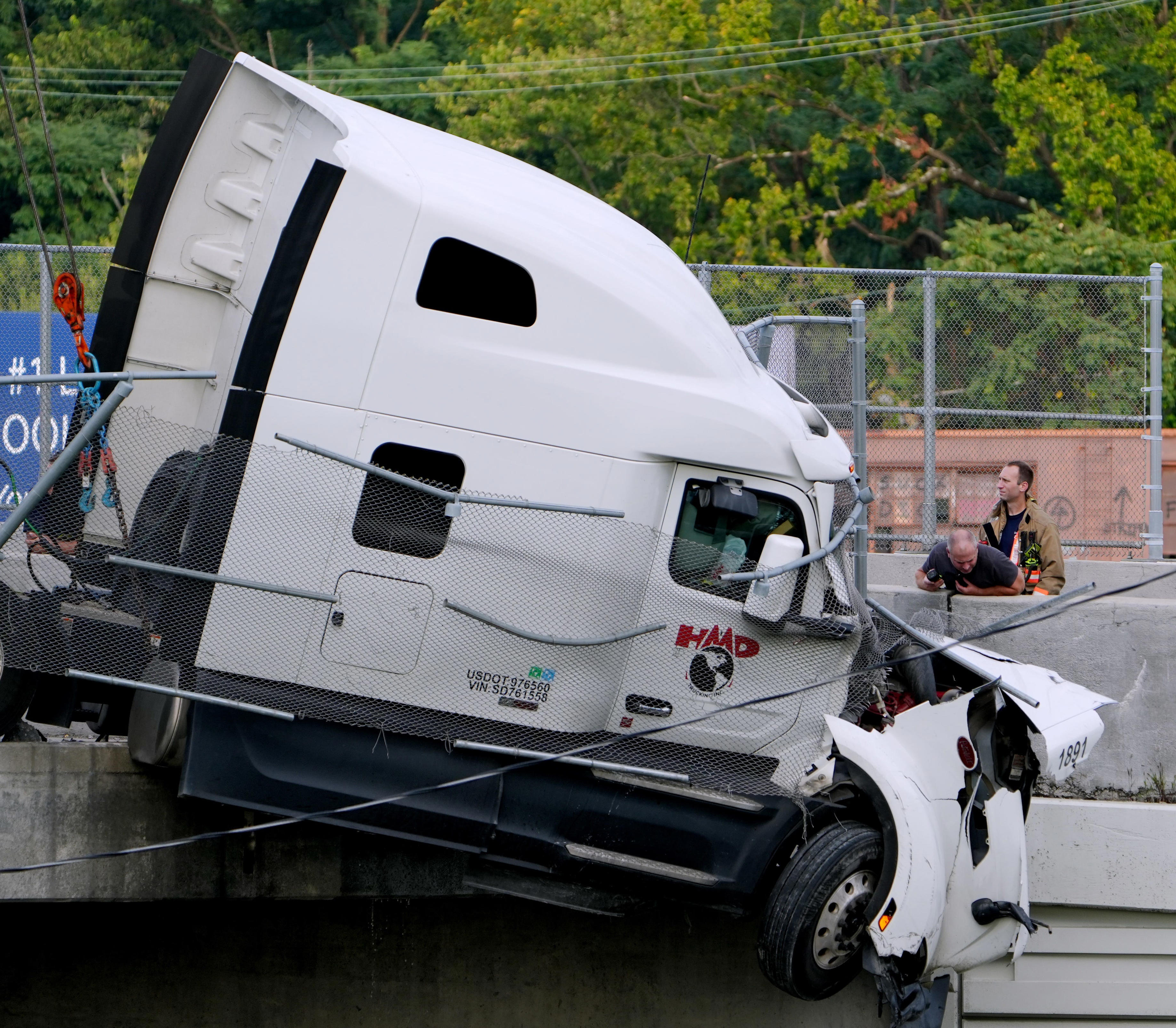 2 pulled from semi hanging off overpass, closures may affect rush hour