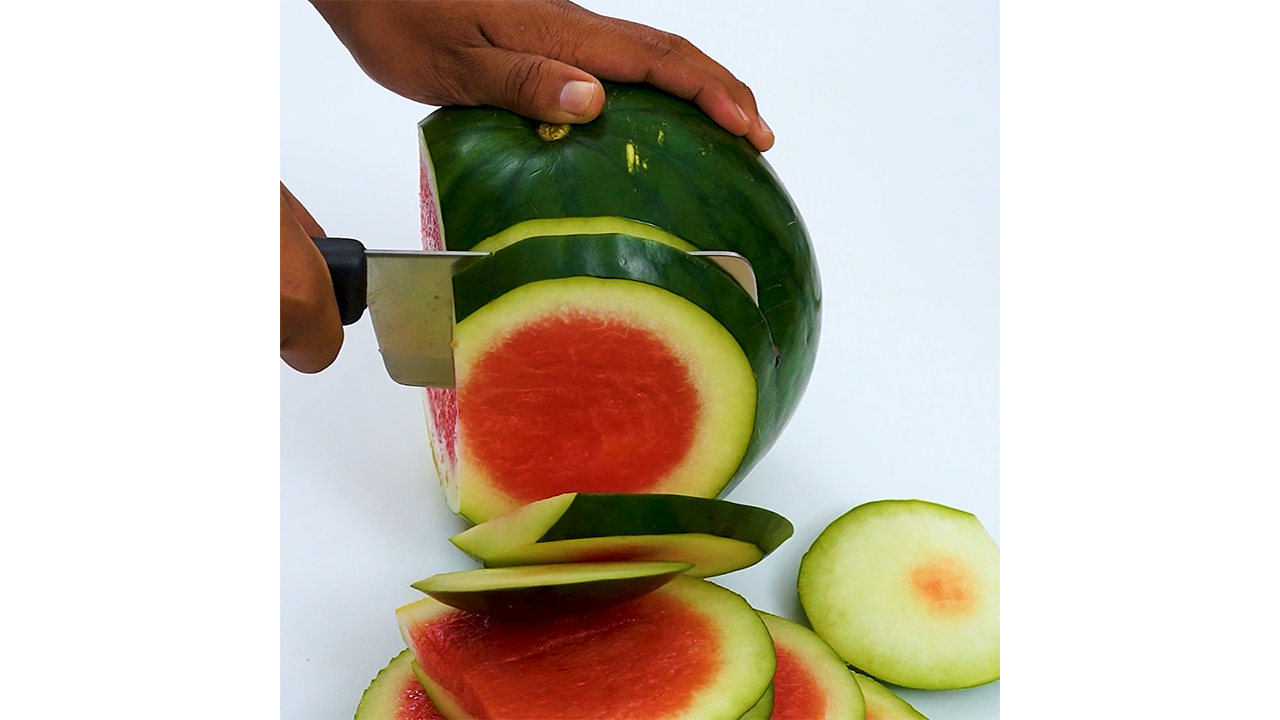 Peeling watermelon rind with sharp knife creating smooth and satisfying ...