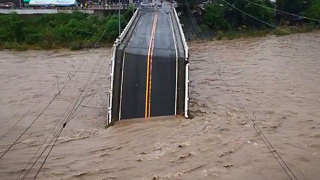 Powerful monsoon floods snap road bridge in half in the Philippines