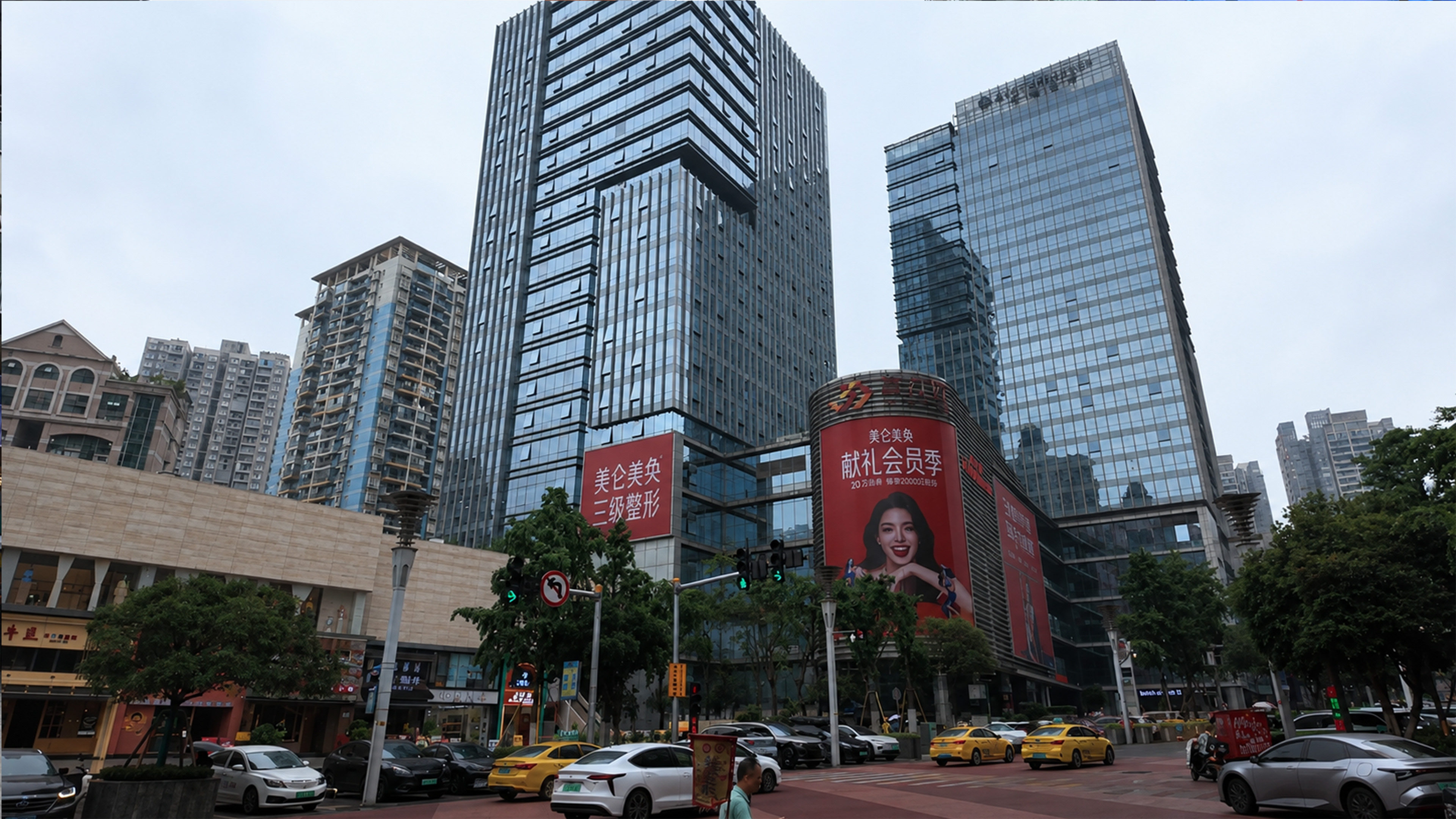 Towering glass buildings dominate this lively Chengdu street corner