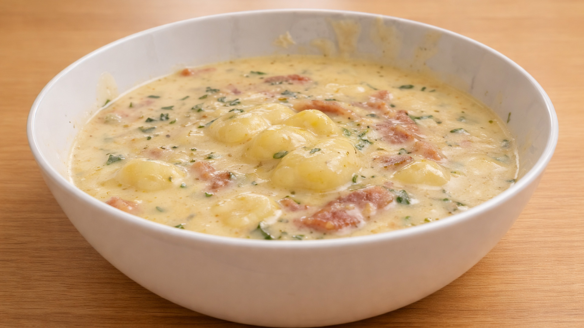 Creamy gnocchi soup with bacon and herbs
