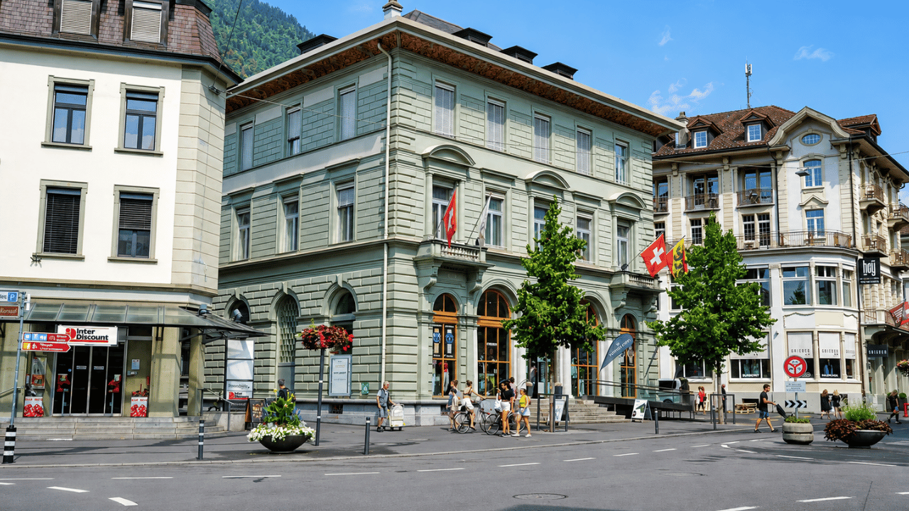 Interlaken streets with Swiss flags and alpine backdrops (4K)