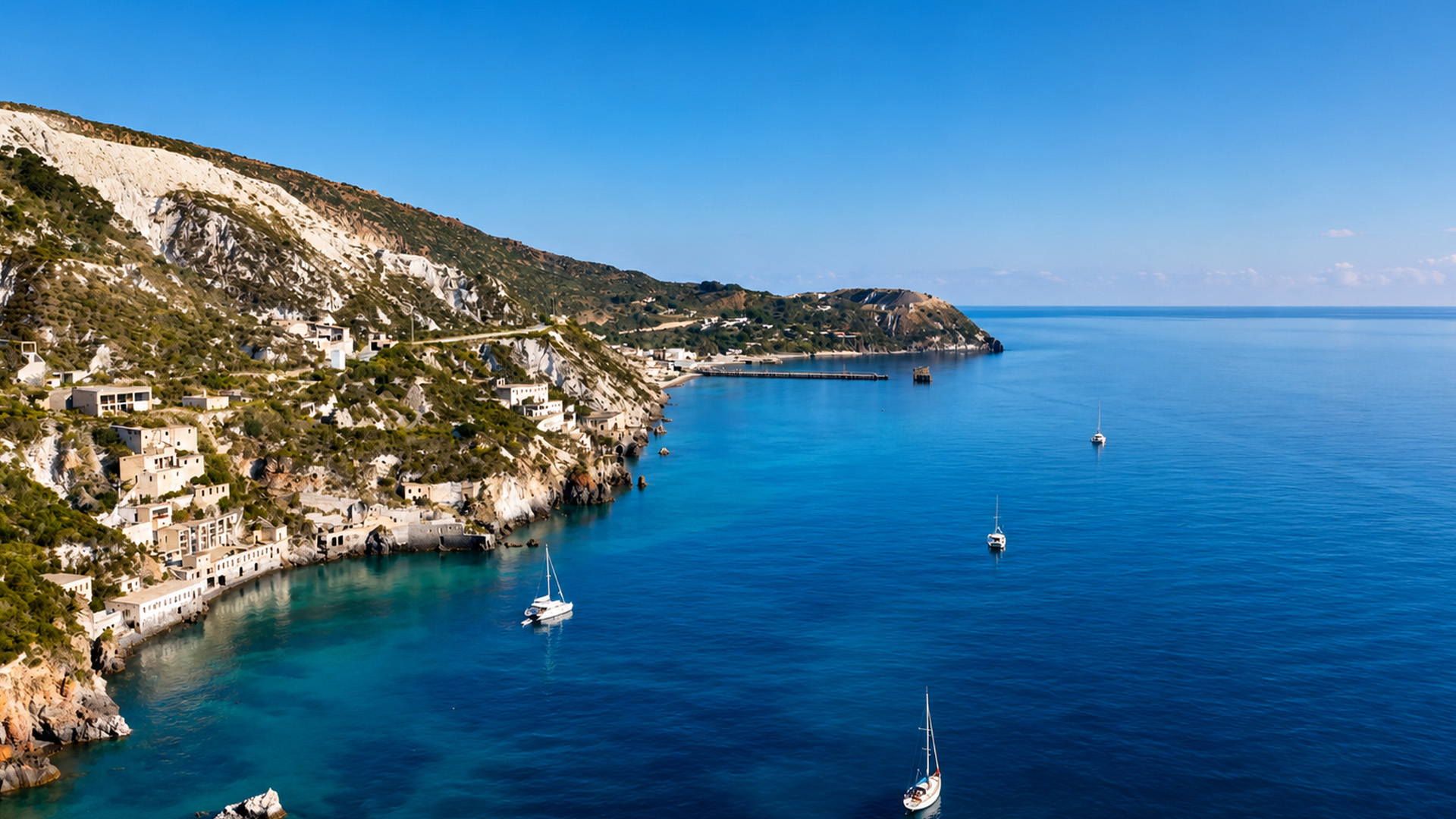 Houses scattered across a steep Mediterranean coast
