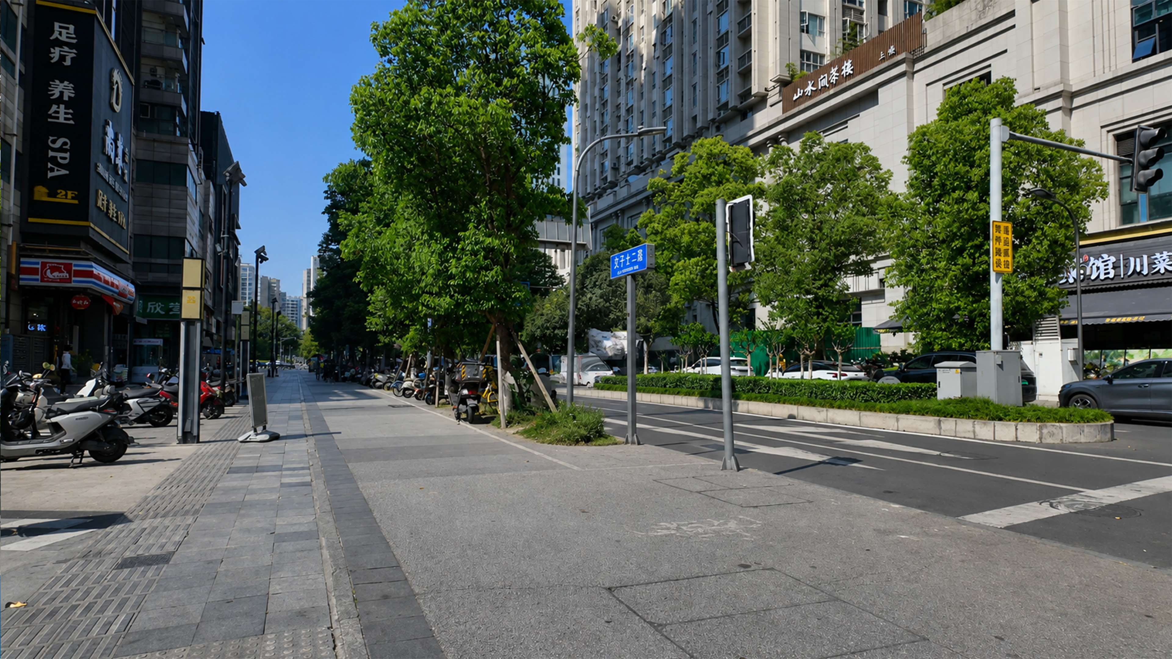 Lush trees shade the sidewalk along this modern Chengdu street