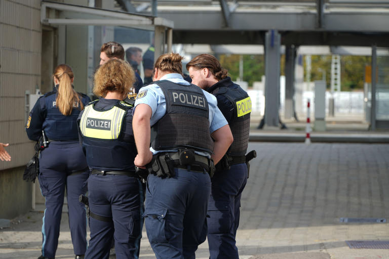 Police officers on the scene following an overnight explosion at Augsburg's main train station (AP)