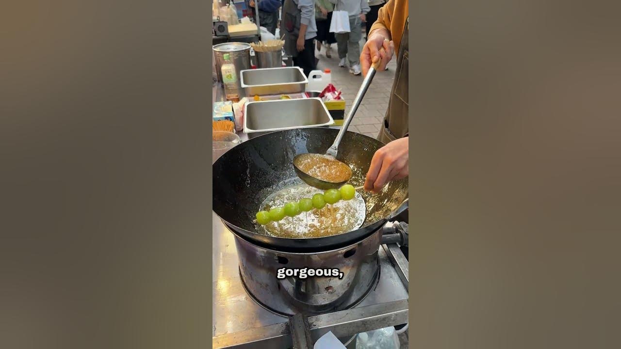 They dip giant grapes into hot sugar... look what happens when it hardens