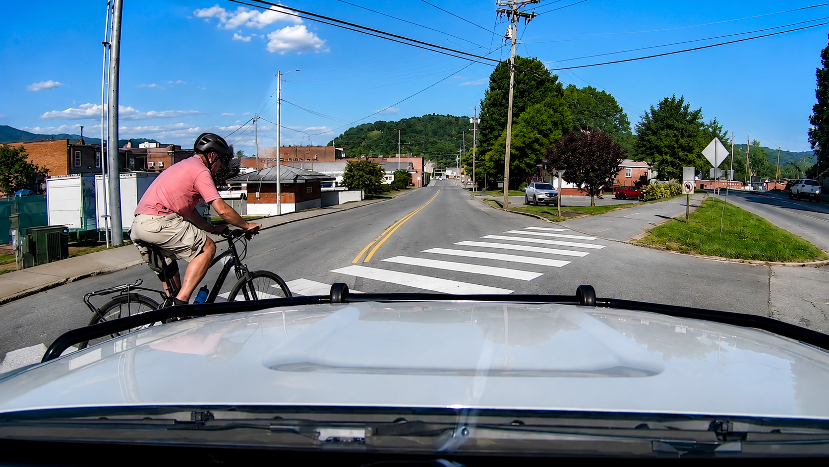 Police car hits a cyclist at a stop sign - caught on dashcam
