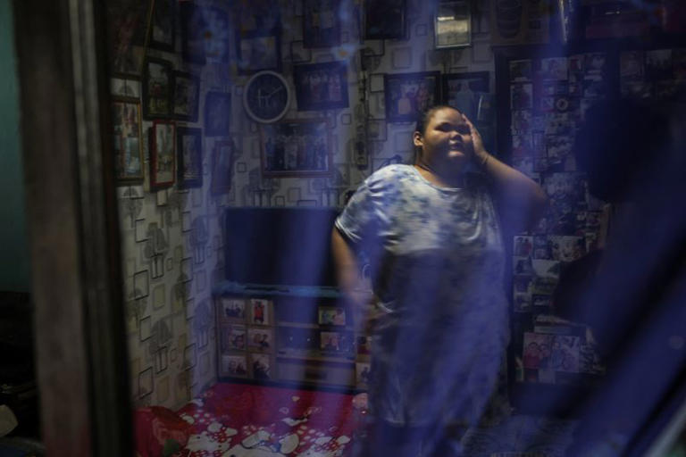 Intan Permatasari, 15, gestures at her home in Bogor, West Java province, Indonesia, August 20, 2026. Intan's confidence has returned as her weight has dropped. She goes to the gym, eats out with her parents, and returned to school last month. She still dreams of becoming a police officer. "They like to help people," Intan said. "I want to prove to people who bully me, who make fun of me, that I can be a hero." REUTERS/Ajeng Dinar Ulfiana
