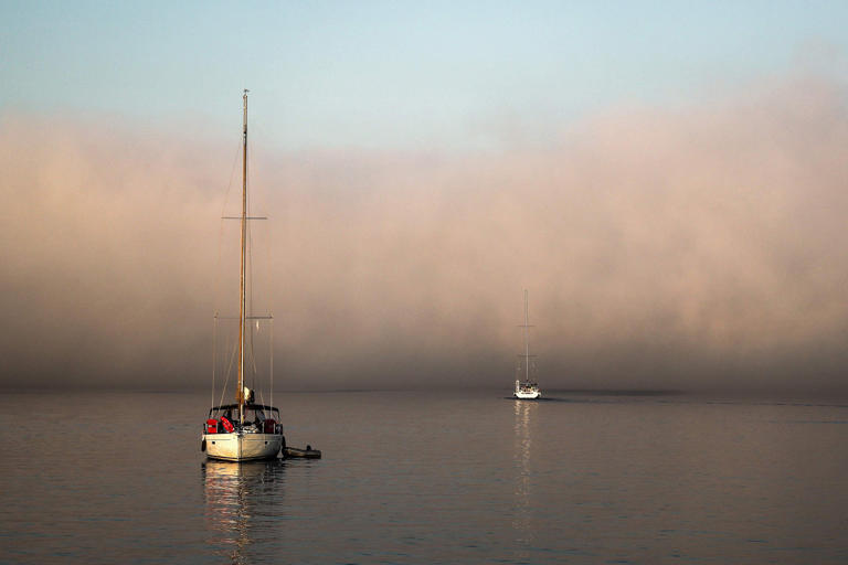 A yacht passes through thick fog in the Aegean Sea near Kimolos Island in Greece's Cyclades. Greece and Turkey have long-standing conflicts over boundaries in territorial waters, continental shelf, and exclusive economic zones (EEZ) in the Aegean region. /AFP-Yonhap