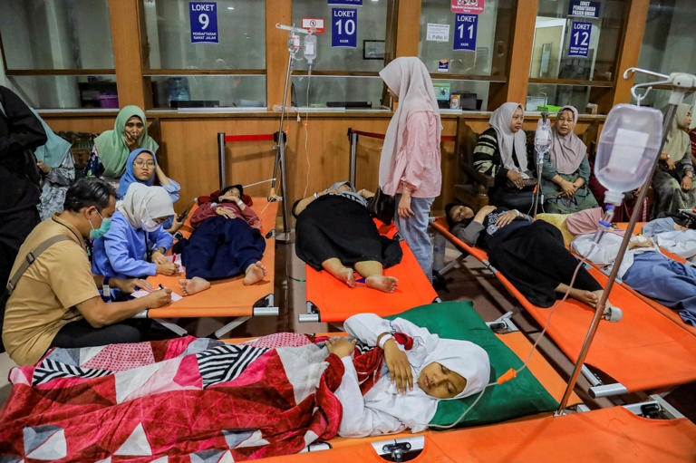 Students rest while receiving treatment for food poisoning at the regional general hospital after eating government-sponsored free school meals in Sidoarjo, East Java, Indonesia, on Wednesday. Photograph: Suryanto/Reuters