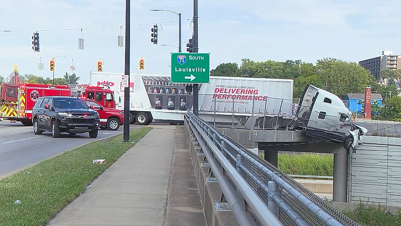 Dramatic crash leaves semi-truck cab hanging off overpass