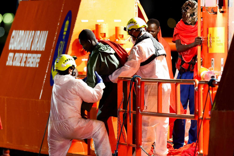 Rescuers helped the survivors to disembark at the Gran Canaria port of Arguineguin this morning (Picture: REUTERS)