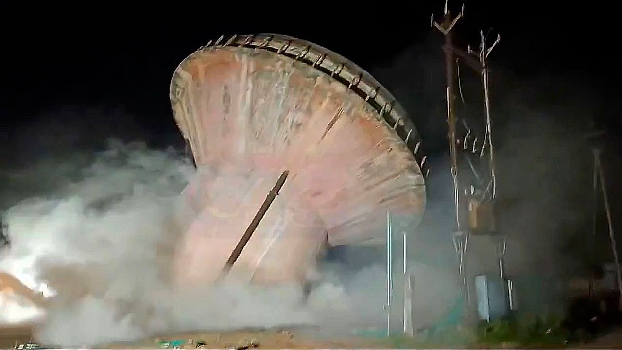 40-year-old water tank dramatically collapses during night demolition ...