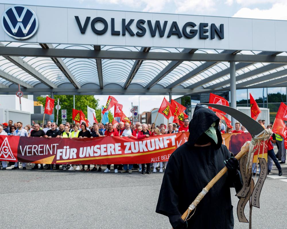Volkswagen to cut further 50,000 jobs as it ends row with union over revival plan