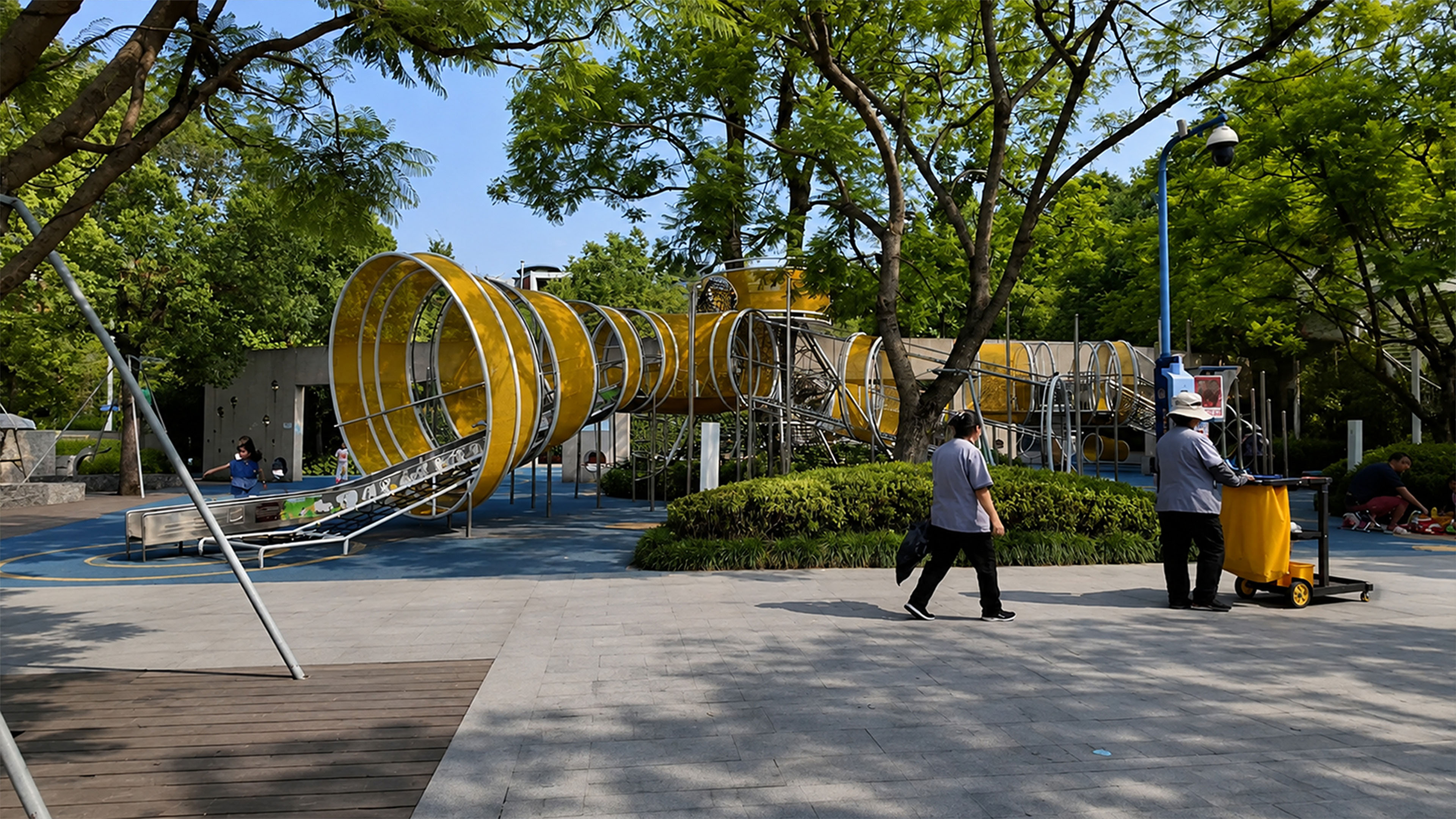 Bold yellow play structures stand out against the green landscape in ...