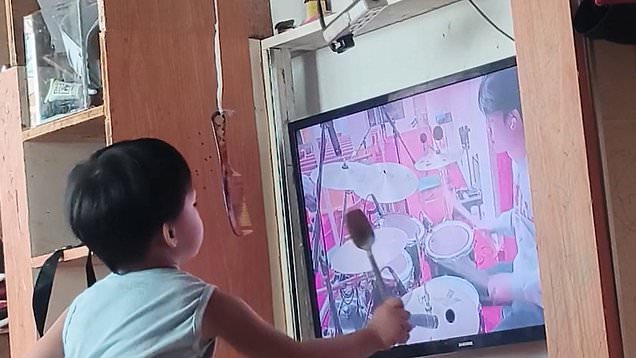 Kid uses mum's TV for drum practice