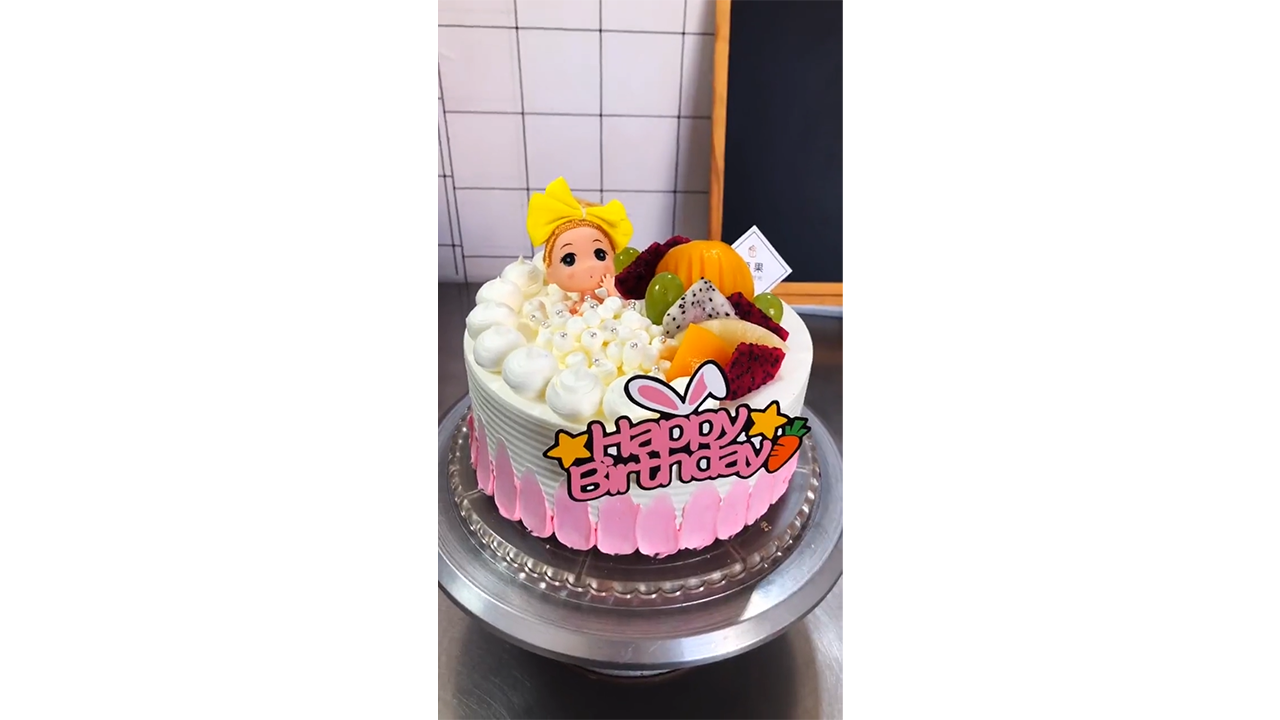 Creating playful pink birthday cake with cute doll topper and tropical ...