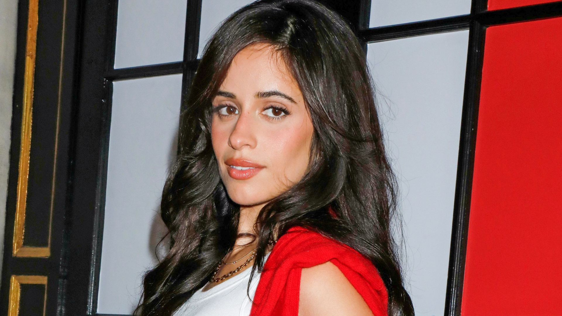Camila Cabello puts a flirty twist on preppy style in a red knit mini ...
