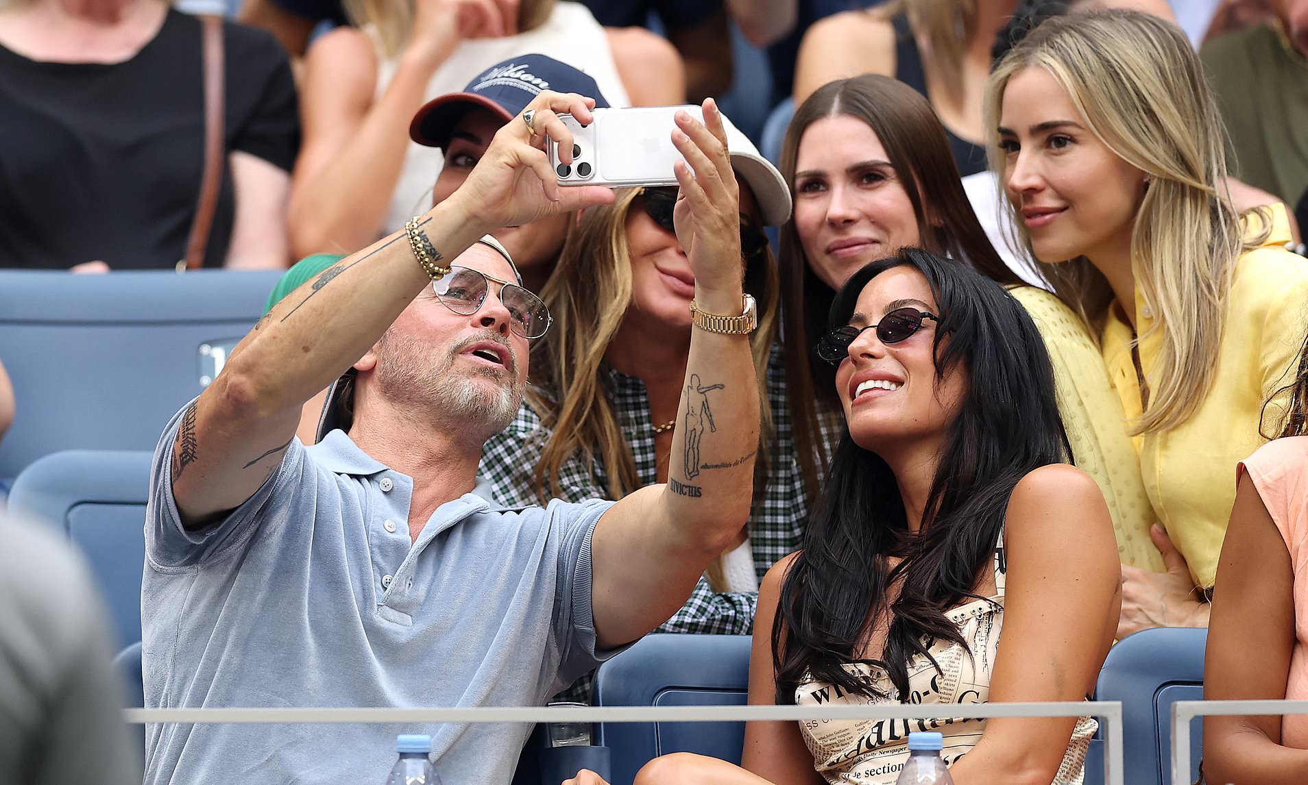 Brad Pitt snaps selfies with adoring fans and cuddles up to girlfriend Ines de Ramon at US Open