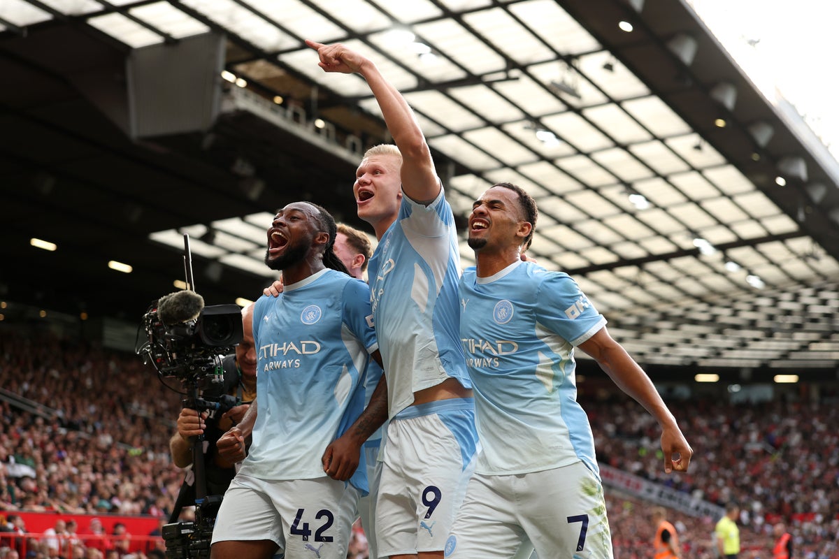 Haaland gives 10-man City the lead with controversial goal in derby