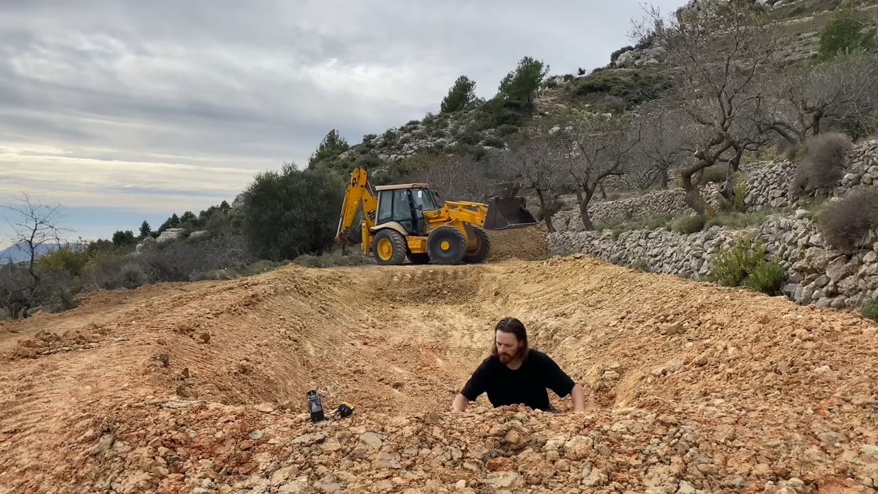 Digging a swale and pond drainage channel