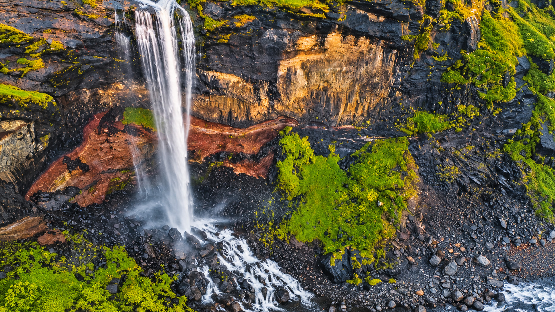 Waterfall cascading down the rugged cliffs of the Faroe Islands