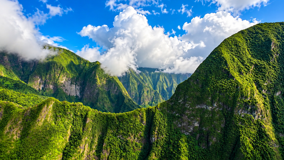 lush-green-mountains-rise-into-towering-tropical-clouds