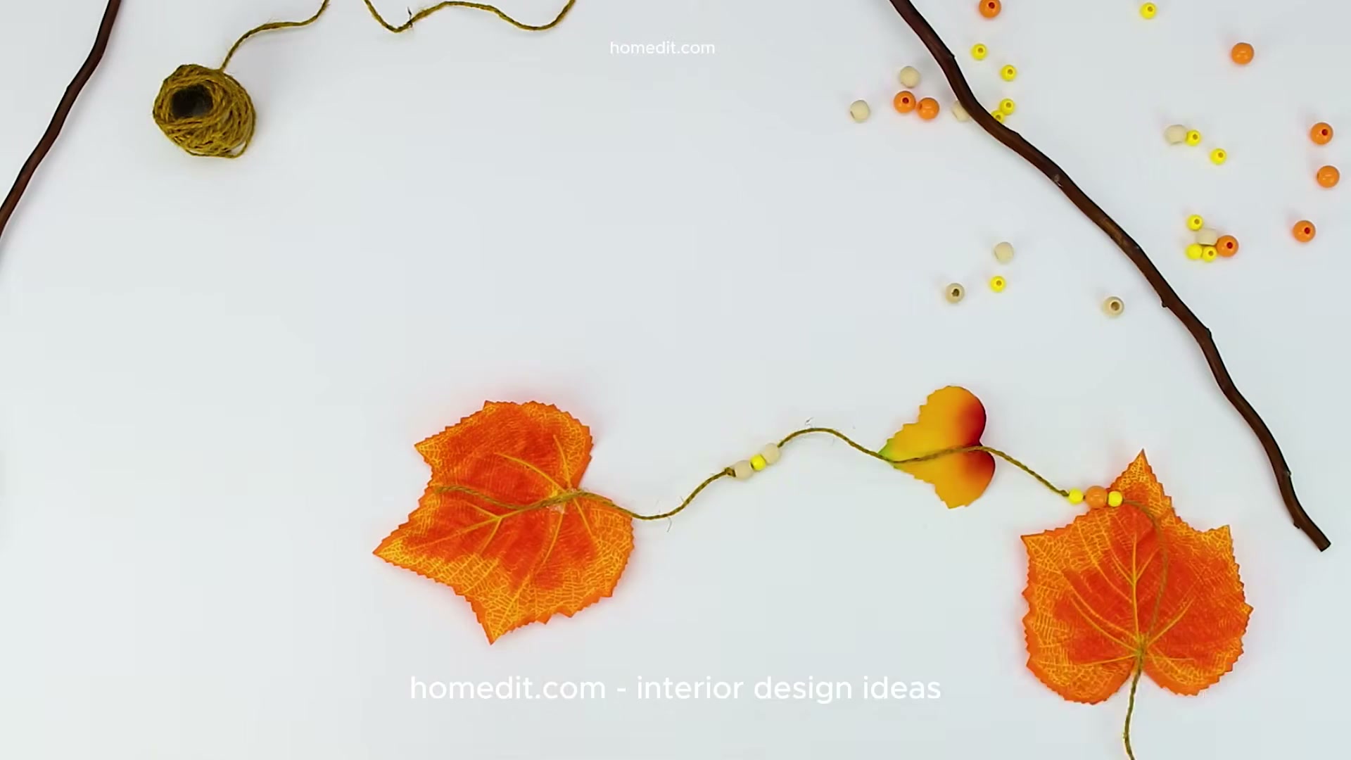 She strung fall leaves and beads from a branch for an easy autumn wall ...
