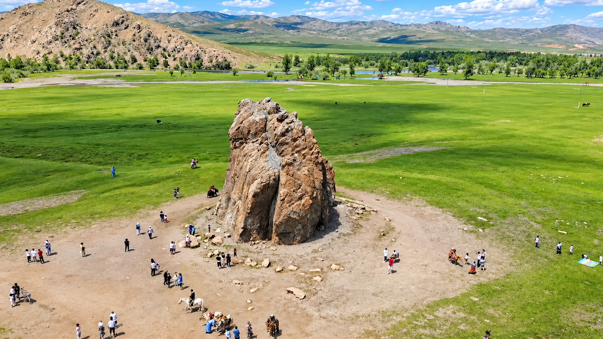Why do people gather around this isolated rock?