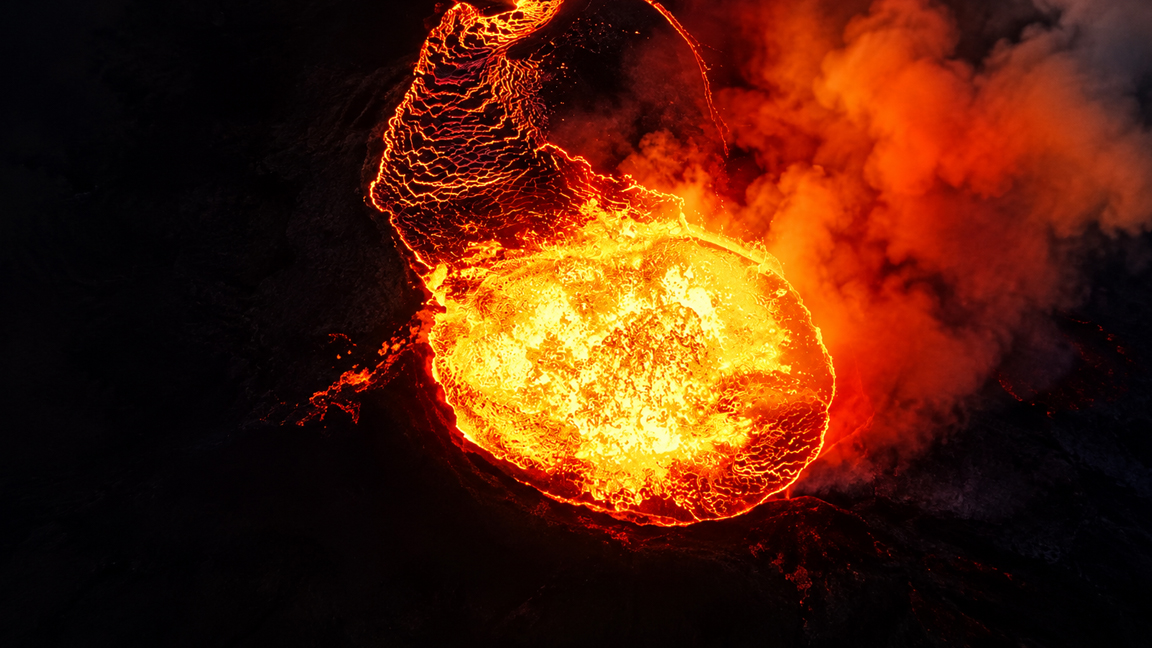 Molten lava glows inside an active volcanic crater