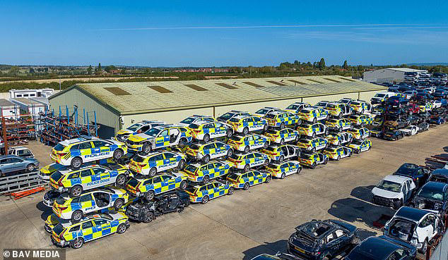 Dozens of smashed police vehicles line scrapyard with wall of wrecks ...