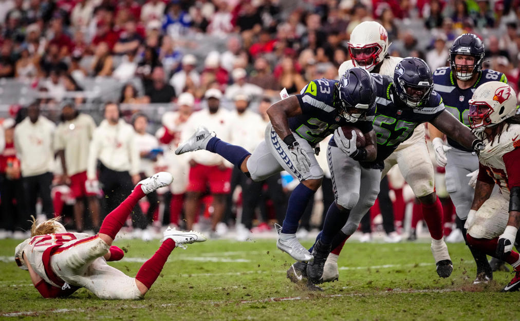 Seattle Seahawks running back Emanuel Wilson (23) breaks a tackle from Arizona Cardinals safety Andrew Wingard (28) during a game at State Farm Stadium in Glendale, Ariz. on Sept. 20, 2026.