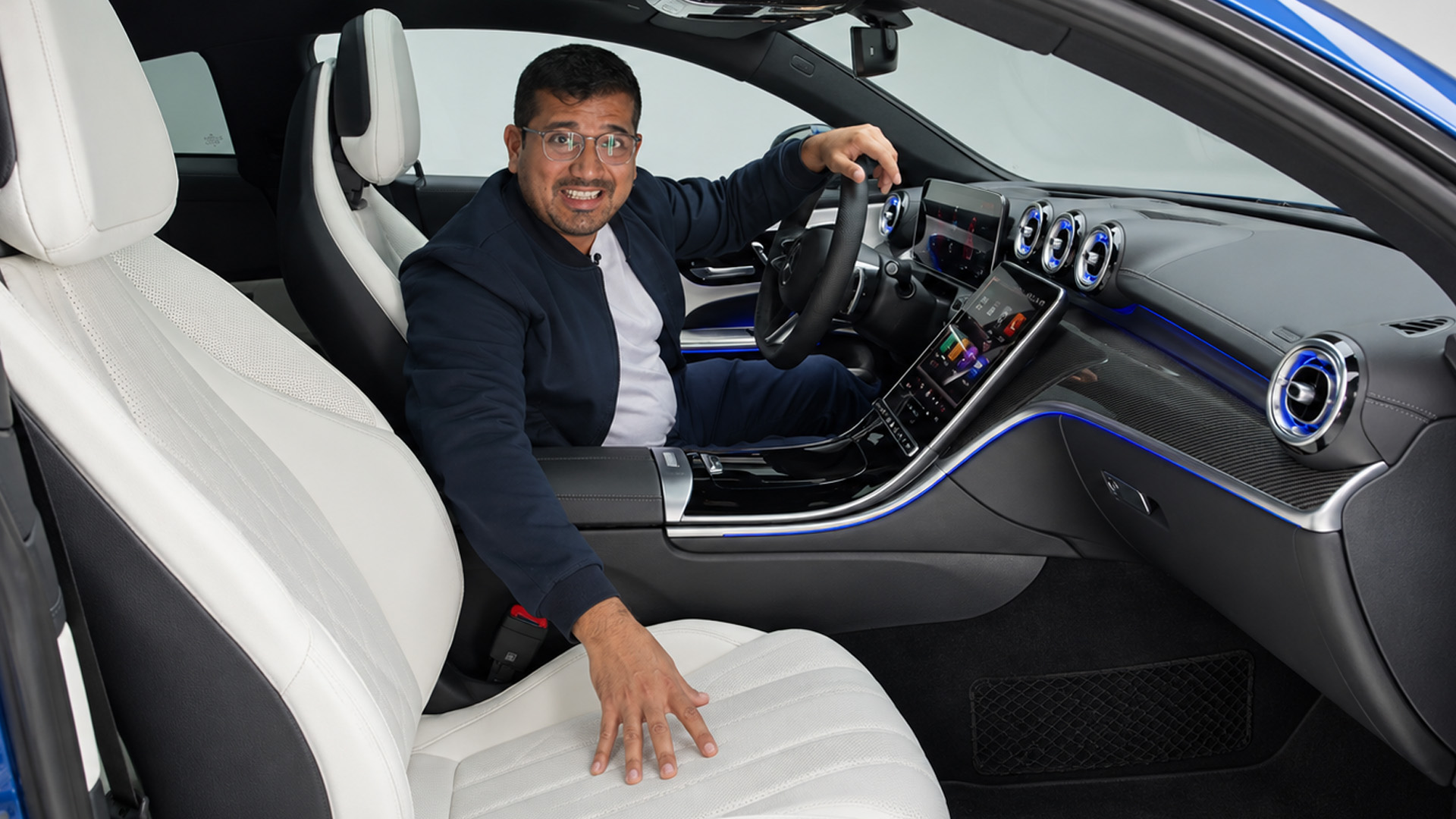 Blue ambient lighting follows the Mercedes CLE coupé dashboard lines