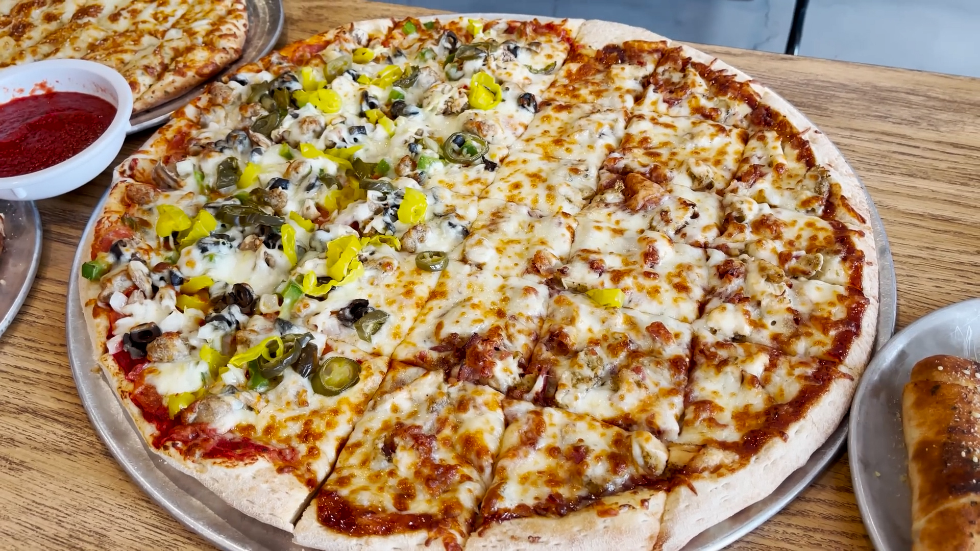 Man attempts massive pizza punishment challenge with cheesy sides