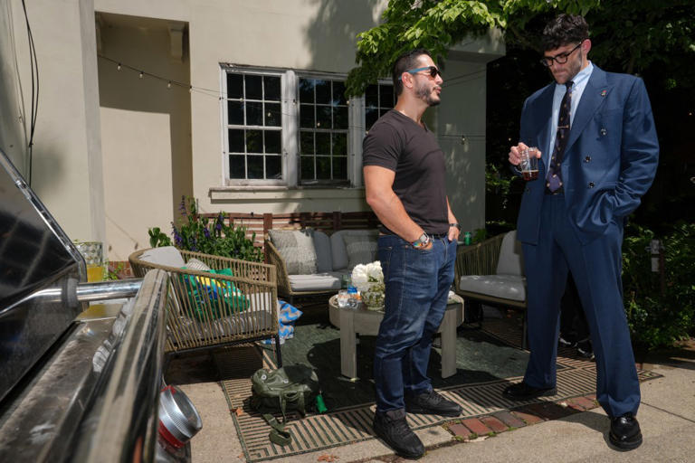 Abdul El-Sayed, a progressive candidate in the Democratic primary for U.S. Senate in Michigan, talks poolside with streamer Hasan Piker at a party for content creators supporting his campaign, Monday, Aug. 3, 2026, in Detroit. (AP Photo/Julia Demaree Nikhinson)