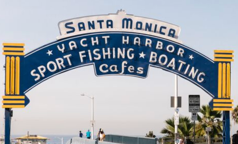 Original pier sign leaves town, half-size replica holds its place