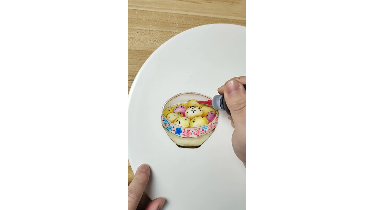 Drawing colorful fruit bowl with ink creating detailed food illustration