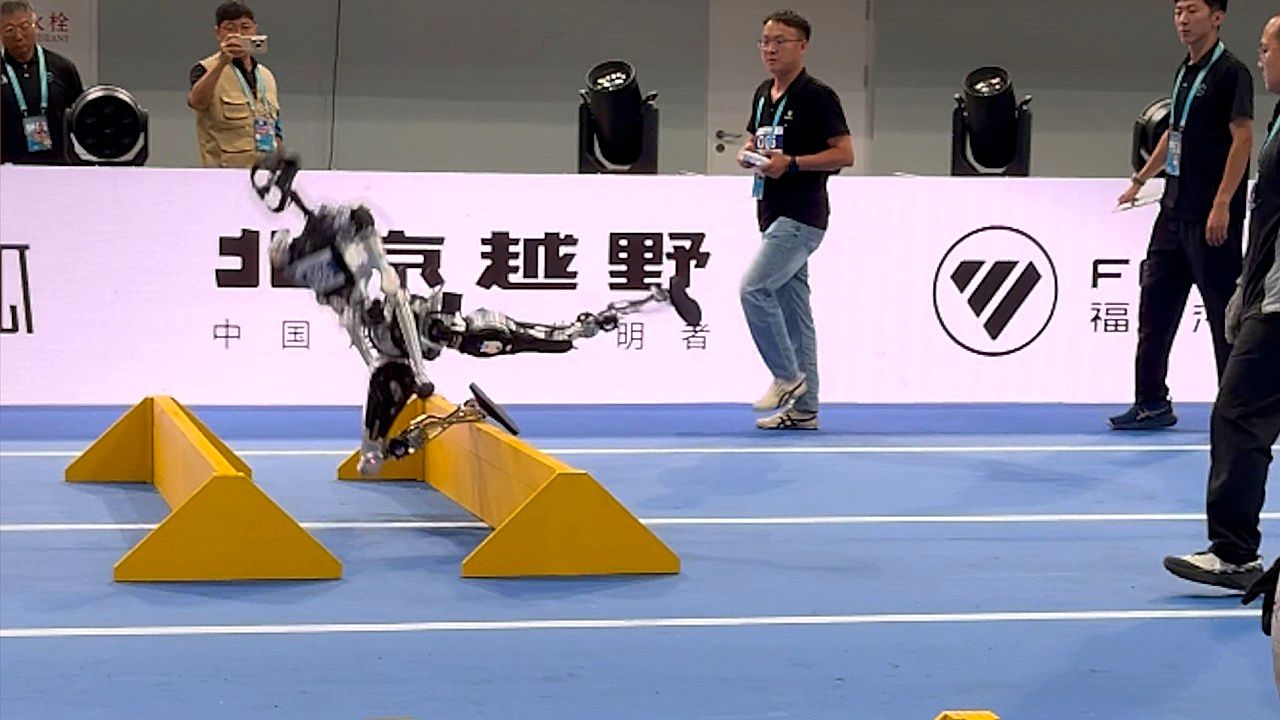 Humanoid robot stumbles at hurdle race during competition in Beijing