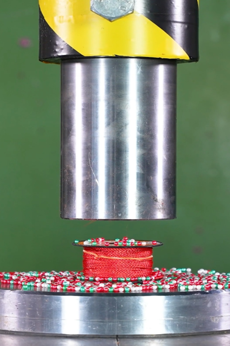Hydraulic press crushes thread spool and beads