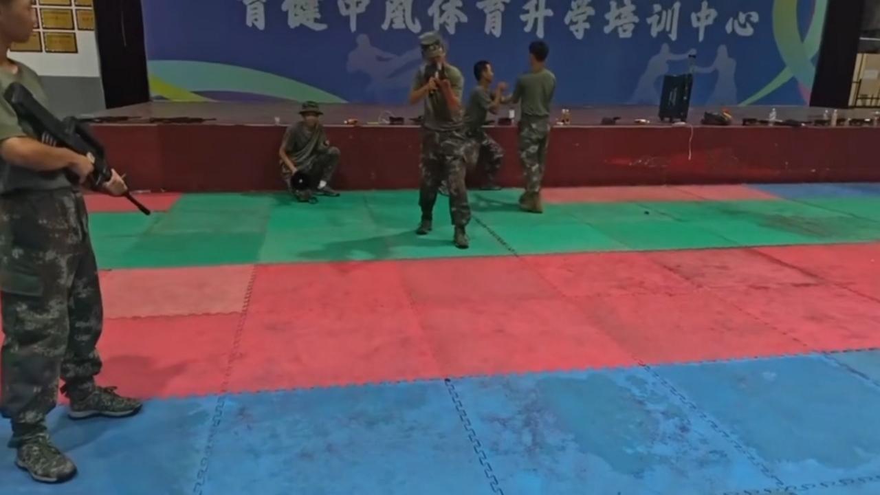 Man rolls over with rifle during military training in Jiangxi